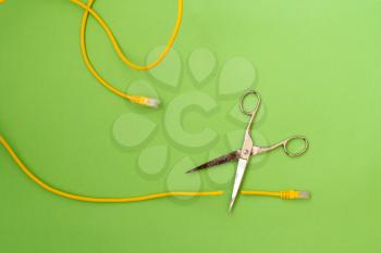 Scissors cut the yellow network cable connector. Internet censorship concept