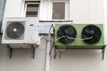 Air conditioning system installed outside on a building wall