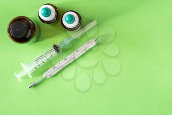 Top view of medical syringe,thermometer,and medical bottles. Copy-space.