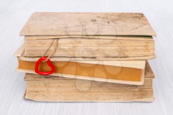 Old books with red heart on the string. Book love concept.Valentine's day concept.