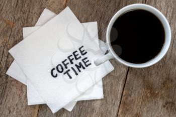 Black coffee cup with COFFEE TIME note on napkin