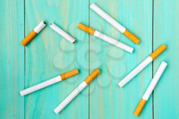 Quit bad habit, health care concept. No smoking.Cigarettes on blue wooden background.