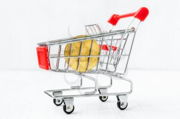 Shopping cart with Bitcoin coin. Concept for buying or selling cryptocurrency