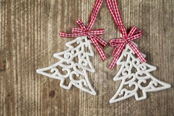Pair of christmas tree baubles on the wooden background with copy-space