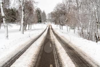 Rural road in winter time covered by snow