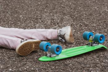 Girl fall off from skateboard. Injury, trauma, accident on skateboard