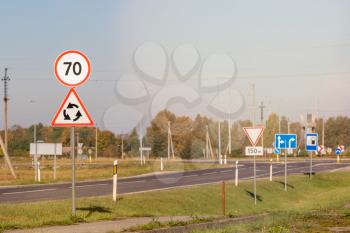 Highway with speed limit 70 road sign, roundabout ahead