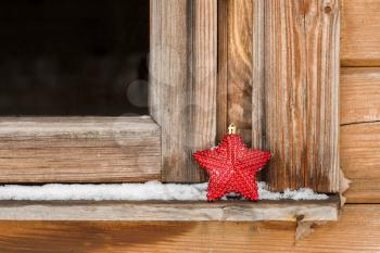Christmas decoration red star on winter windowsill