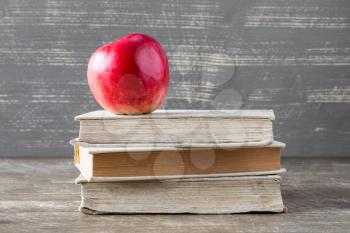 Stacked books with red apple on top. Education concept.