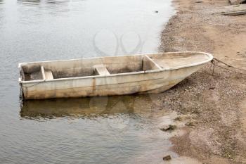 A single old boat on the seashore