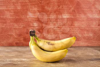 Yellow banana fruits on the wooden background
