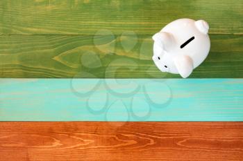 Piggy bank on color wooden background,Saving or financial investment concept