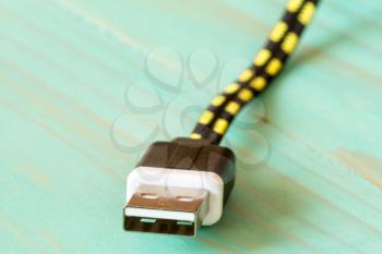 USB cable on blue wooden background