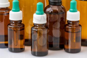 Group of glass bottles with medicine or essential oil. Close up view.