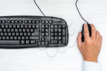  Businessman working with computer mouse and keyboard , top view