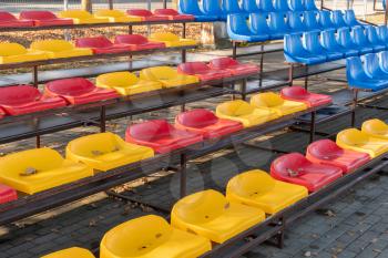 Empty plastic seats at small city stadium