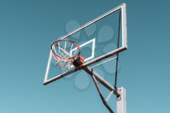 Basketball ring and board. Low angle view. Filtered image.