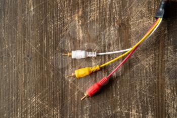 Audio-video analog cable on wooden background with copy-space