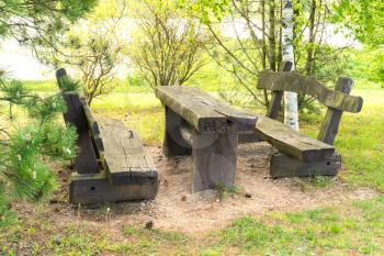 Wooden picnic table with benches in the public park