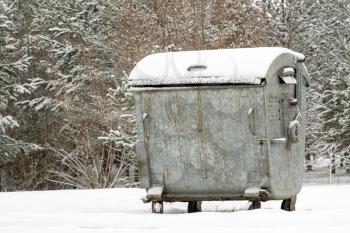 Big gray garbage container in a winter park
