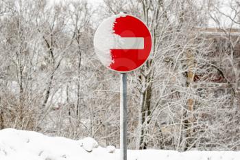 Red road sign travel is prohibited, on the background of the winter landscape