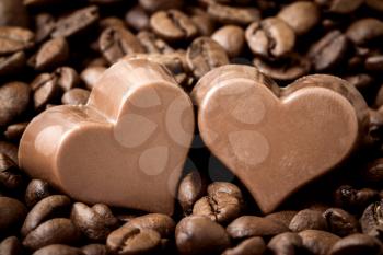  Couple chocolate hearts on a coffee beans pile