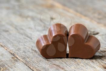 Couple of chocolate hearts dessert on a wooden background