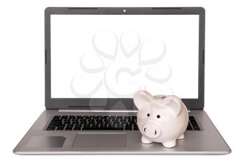 Piggy Bank on laptop keyboard, isolated on white background,copy-space