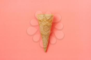 Sweet wafer cone on pink background
