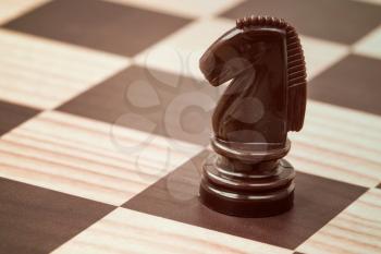 Shot of a chess board with brown horse 