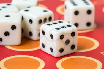  Several white dice on board game background