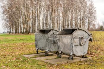 Old metal garbage containers in the countryside