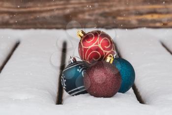 Christmas composition with christmas baubles in a snowy weather