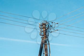 Electrical pole and cables on the clear sky background