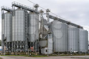  Modern storage technology agro-industry. Silos of grain elevator. Metal bins for grain storage.