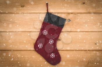 Christmas stocking hanging on wall outside in a snowy weather