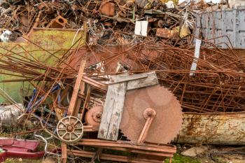 Scrap metal waste is stored in a recycling yard waiting to be melted down to manufacture new products