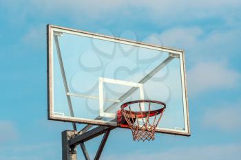 Basketball Net System with rim in front of blue sky background