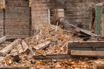 Demolished old wooden house in the city. Scattered elements of the building
