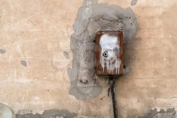 Old electric control box on the concrete wall. Copy space.