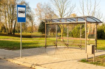 Landscape with empty bus stop in a sunny morning