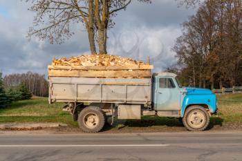 Dump truck with a body full of firewood ready to delivery