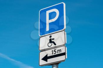 Signpost for disabled and invalid parking. Close-up view