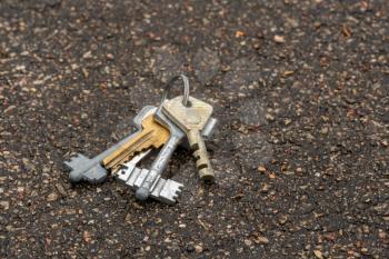 Bunch of keys lying lost on pavement