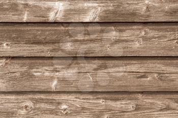 Background from four horizontal old wooden planks. Wall of old barn.