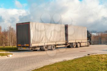Truck with goods delivery waiting in front of the gate 