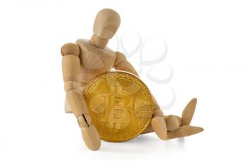 Wooden man holding Bitcoin while sitting on white background