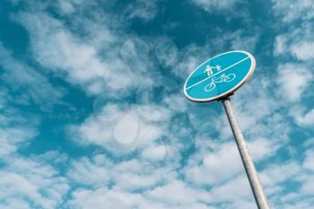 Pedestrian and bicycle road sign under sky background. Low angle photography