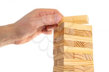 Hand arranging wood block stacking as tower. Business concept for growth success process. Closeup of businessman making a pyramid with wooden cubes.