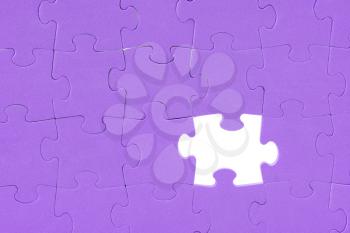 Purple jigsaw puzzle background with one missing piece